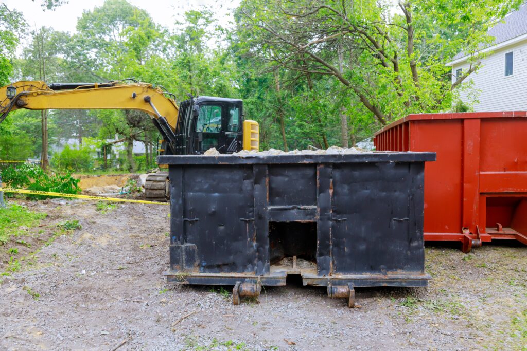 Industrial dumpster filled loaded rubbish removal container renovation building on house under construction